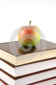 Books pyramid with apple on top