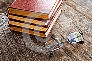 Books and reading glasses on table