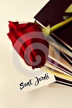 Books, red rose and text Sant Jordi photo