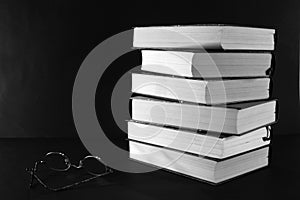 Books stack with glasses