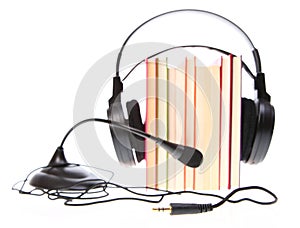 Books stack and headset with a microphone isolated