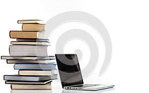 Books stack and a laptop on white background
