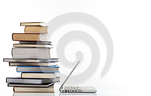Books stack and a laptop on white background