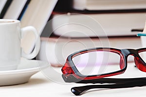 Books stacked glasses on the table