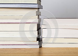 Books stacked on a wooden table.