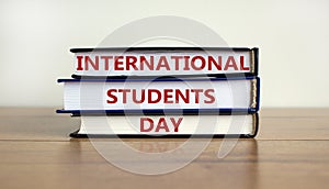 Books with text `International Students Day` on beautiful wooden table, white background. Business and educational concept. Copy