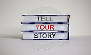 Books with text `tell your story` on beautiful white background. Business concept. Copy space