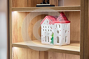 Bookshelf with a toy house on it
