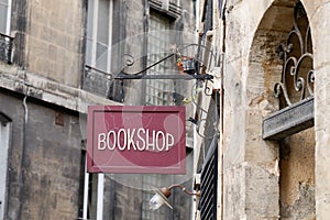 Bookshop sign on steel plate vintage signage of bookstore in city street in ancient european city photo