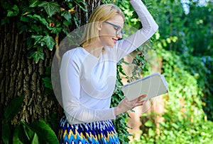 Bookworm student relaxing with book green nature background. Literature as hobby. Spend leisure with avail. Girl keen on