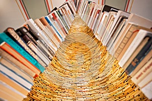 Bookworm tower built from old novels and volums of historical library. Huge installation with many vintage books