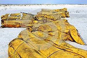 Boom on white sand beach for oil cleanup