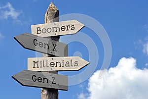 Boomers, Gen X, Millenials, Gen Z - wooden signpost with four arrows photo