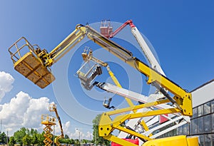 Booms and top parts of different articulated boom lifts