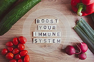 Boost your immune system text with fresh vegetables. Healthy lifestyle, wellbeing concepts