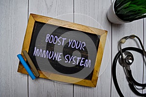 Boost Your Immune System write on a chalkboard isolated on office desk