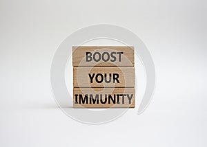 Boost your immunity symbol. Concept word Boost your immunity on wooden blocks. Beautiful white background. Helthcare and Boost photo