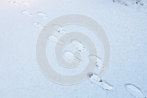 boot prints in the snow, snow surface with footprints