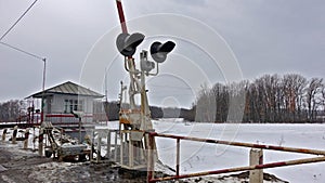 Booth, semaphore and barrier at a railway crossing in Russia