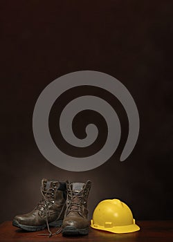 Boots and Construction Helmet on Brown With Copy Space Vertical