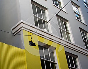 Boots hanging on a cable with colored houses in the background. Vancouver, BC, Canada