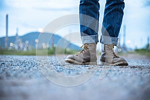 Boots safety worker at construction site. Engineer Wear Jeans And Brown Boots for Worker Security on Background of Refinery.