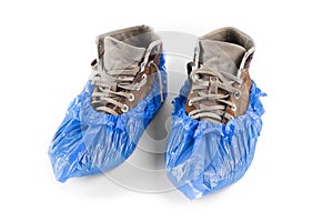 Boots in shoe covers on a white background