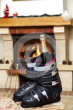 Boots ski boots in front of fireplace