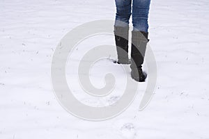 Boots trudging through snow