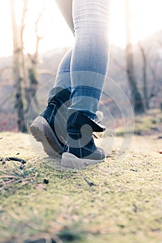 Boots of a young woman, cutout, outdoors in timberland, autumn