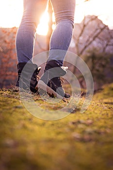 Boots of a young woman, cutout, outdoors in timberland, autumn