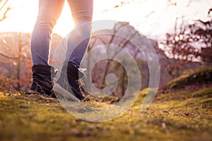 Boots of a young woman, cutout, outdoors in timberland, autumn