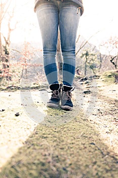Boots of a young woman, cutout, outdoors in timberland, autumn photo