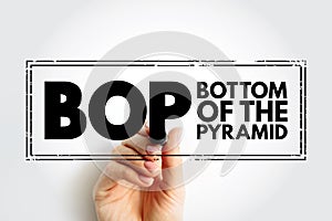 BOP Bottom Of the Pyramid - the largest, but poorest socio-economic group, acronym text stamp concept background