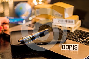 BOPIS - Buy online pickup in store - still life logistics business concept with laptop, phone, mini shipping cartons