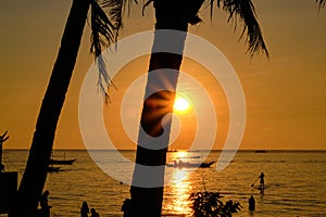Boracay, Philippines - Jan 27, 2020: Sunset on Boracay island. Sailing and other traditional boats with tourists on the