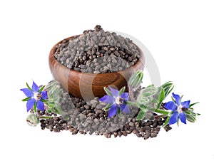Borage seeds with flowers in wooden bowl, isolated on a white background. Borago officinalis seeds and flowers.