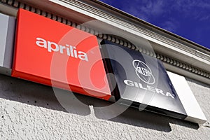 Aprilia and gilera Italian motorcycle company sign and text logo dealership store of