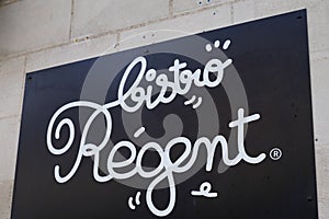 Bistro regent French Bar restaurant sign text and logo on building wall
