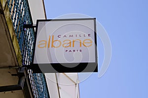 Camille albane logo and text sign on shop front of barber store women hairdresser