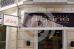 Camille albane sign text and logo brand shop front store women hairdresser salon