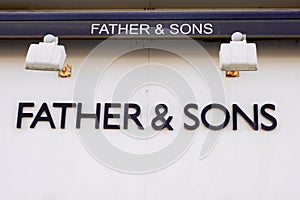 Father & Sons wall facade brand logo text sign on entrance  store German luxury