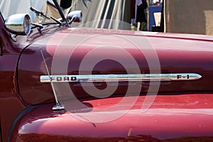 Ford f1 logo brand and text sign on red truck pick up old vintage rust front hood car