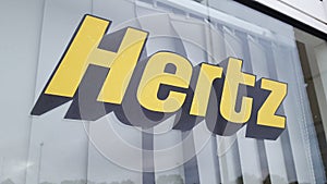 Hertz logo and text sign of American car rental company with international locations