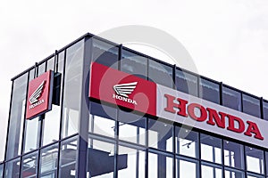 Honda wing motorbike logo store motorcycle sign text dealership shop red colour