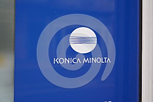 Konica Minolta logo and text sign on wall office building of Japanese technology