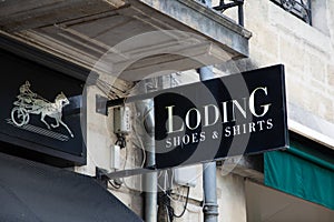 Loding logo brand and text sign front facade store Shoes and shirts shop fashion