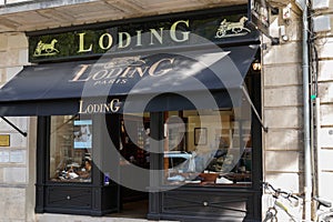 Loding paris logo and tex sign front of boutique store Shoes & shirts shop men and