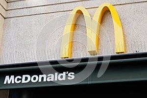 M yellow mcdonald logo and sign on building wall of mcdonalds restaurant fast food