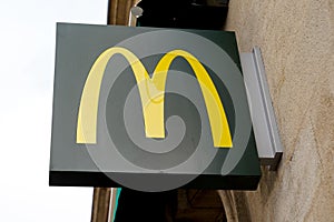 McDonalds logo m yellow sign of global chain of fastfood restaurant store